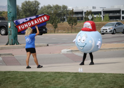 Bubble man with person holding fundraiser sign